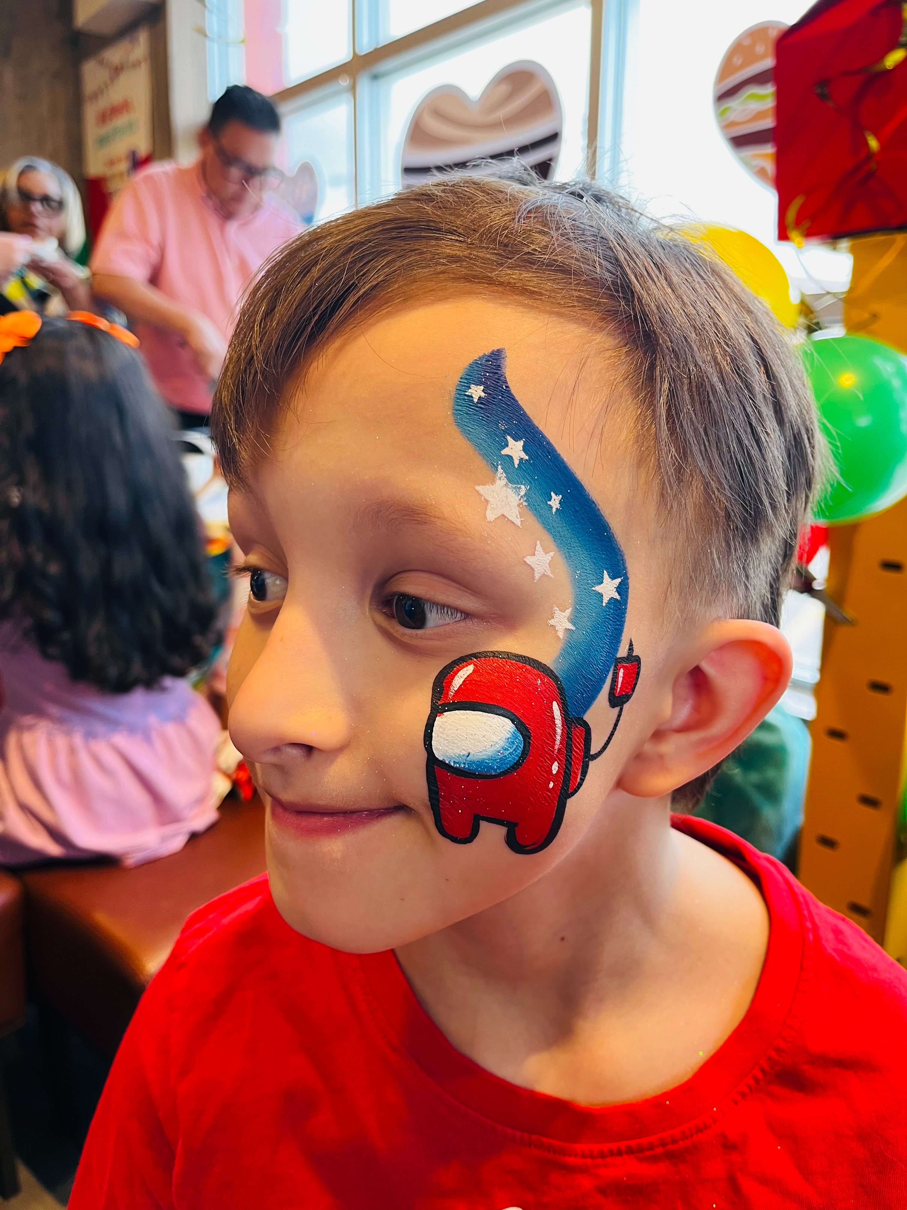 Boy with Among Us character face paint