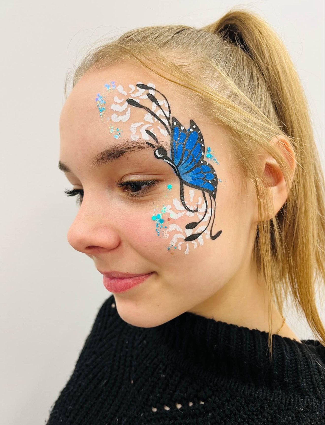 Teen with intricate blue butterfly side design